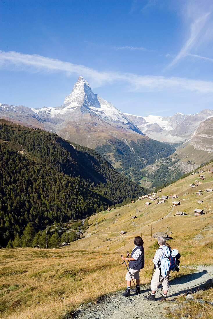 Couple hiking, enjoying the view to the Matterhorn (4478 metres), Sunnegga, Zermatt, Valais, Switzerland