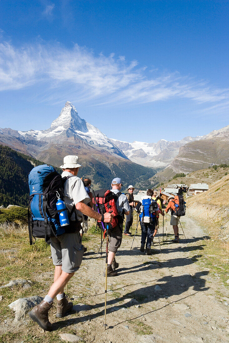 Group of hikers arriving the mountain village Findeln, Matterhorn (4478 m) in background, Zermatt, Valais, Switzerland