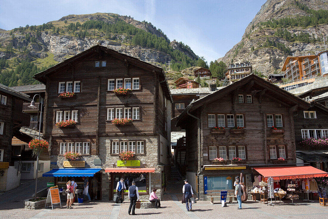 Tourists walking over Bahnhofplatz, Zermatt village, Zermatt, Valais, Switzerland