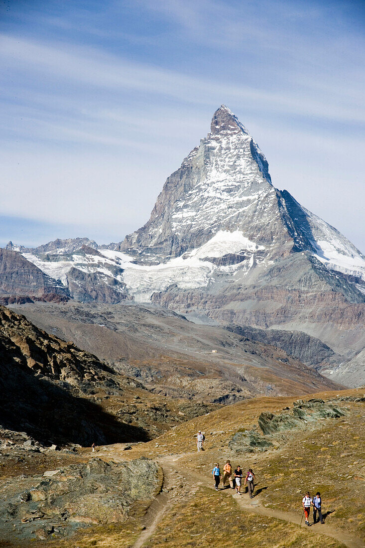 People hiking, enjoying the view to the Matterhorn (4,478 metres), Gornergrat, Zermatt, Valais, Switzerland