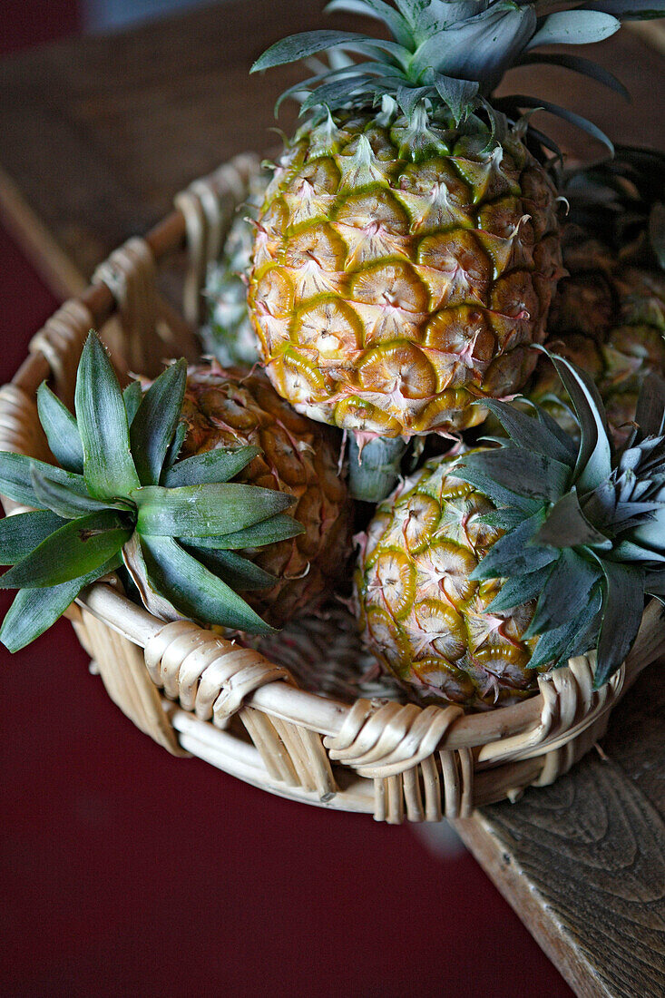 Basket with pineapples on table, Azores, Portugal