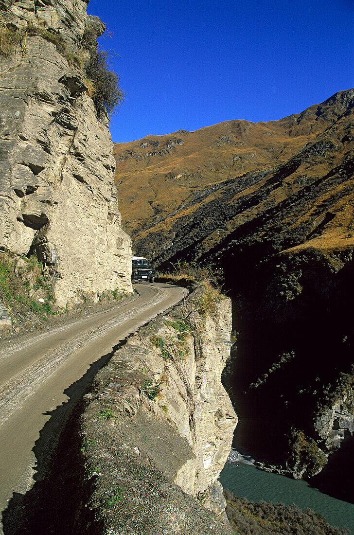 Driving a mountainroad in Skipper's canyon. The riveris called Shotover