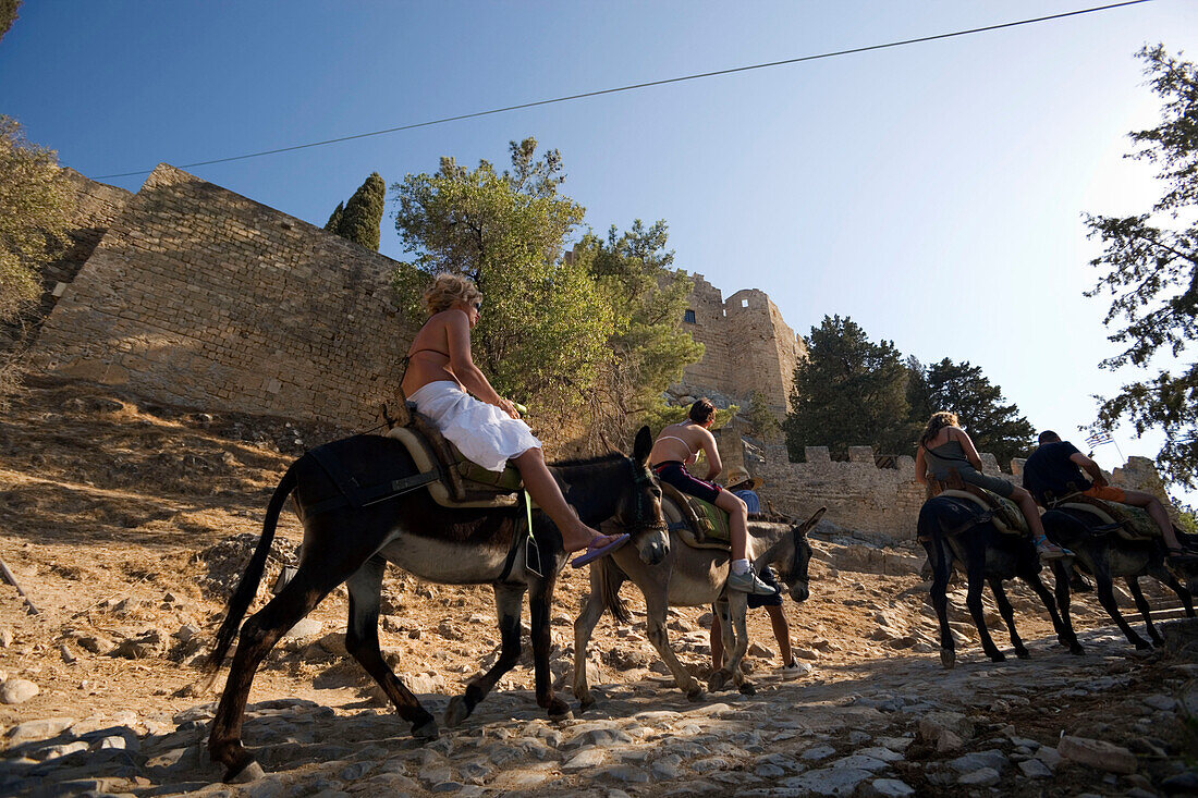 Tourists riding on donkeys to Acropolis, Lindos, Rhodes, Greece