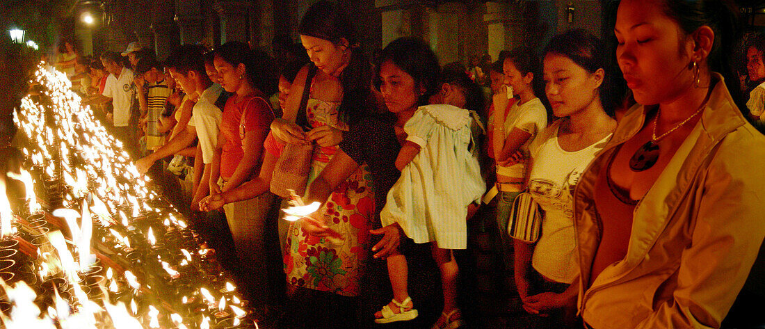 Praying people in the Santo Nino Cathedral, Cebu CIty, Cebu Island, Philippines