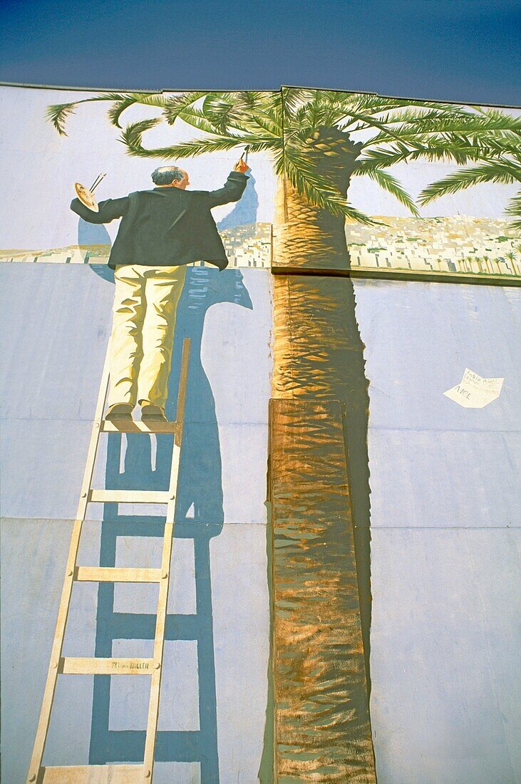 Man painting palm tree standing on ladder, Art, Nice, France