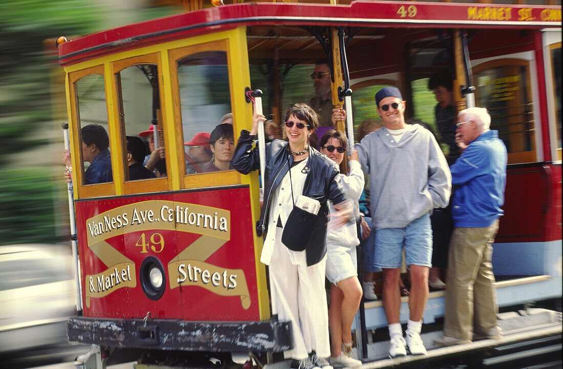 California San Francisco cable car tourists in full speed