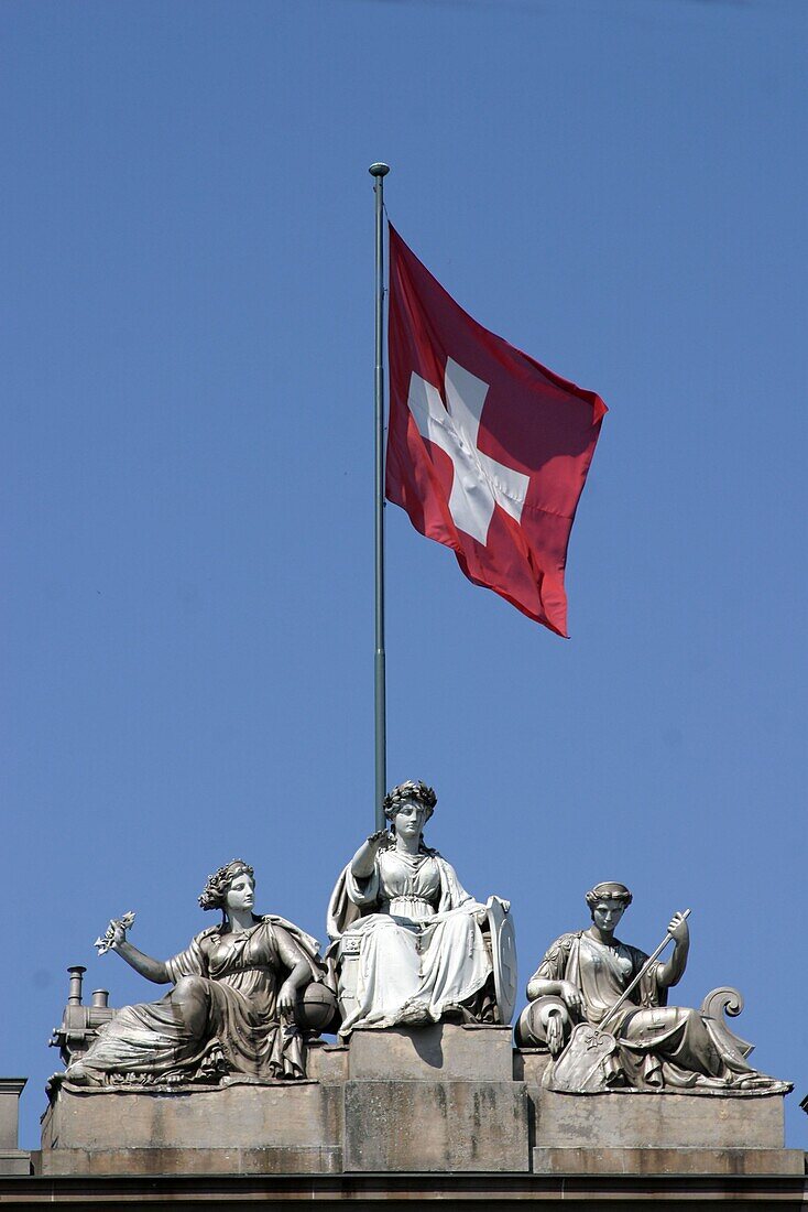 Switzerland, ,Zürich, main station, sculptures on roof top with swiss flag