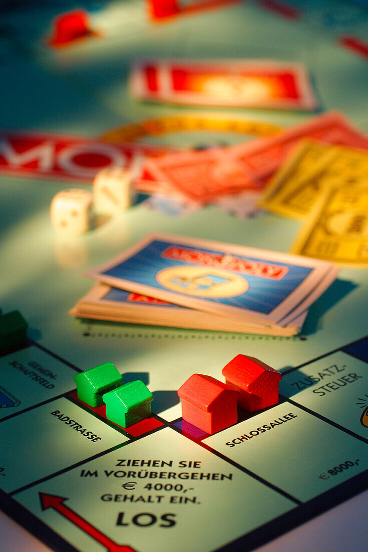 Toy houses on Monopoly board game