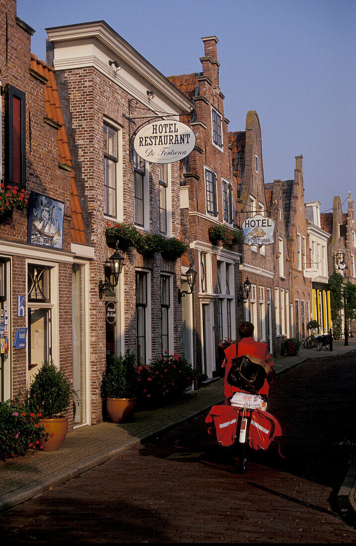 Edam, street with postman on bicycle, Netherlands, Europe