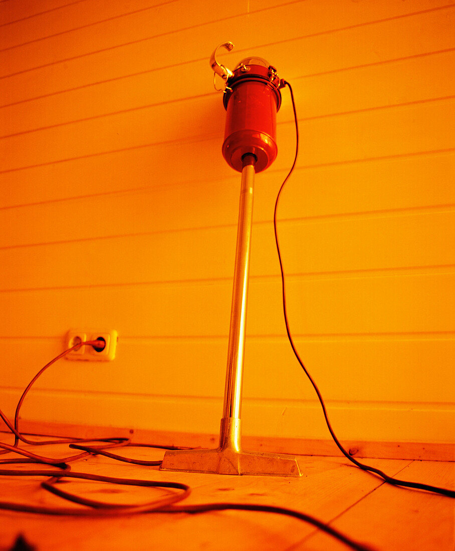 Old vacuum cleaner leaning against a wall