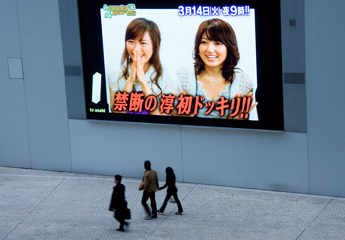 People in front of video screen, Tokyo, Japan