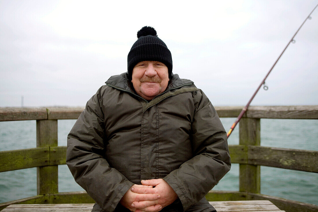 Mature man on pear at Baltic Sea, Mecklenburg-Western Pomerania, Germany