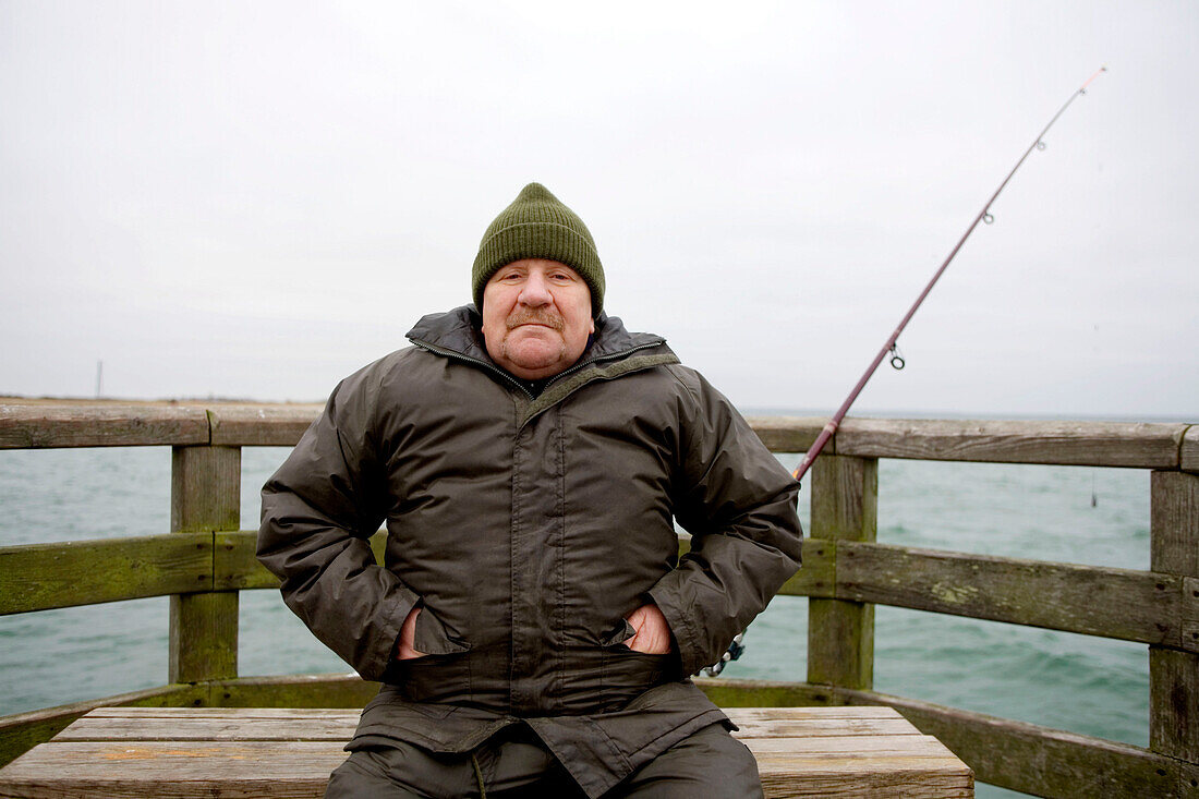 Mature man on pear at Baltic Sea, Mecklenburg-Western Pomerania, Germany