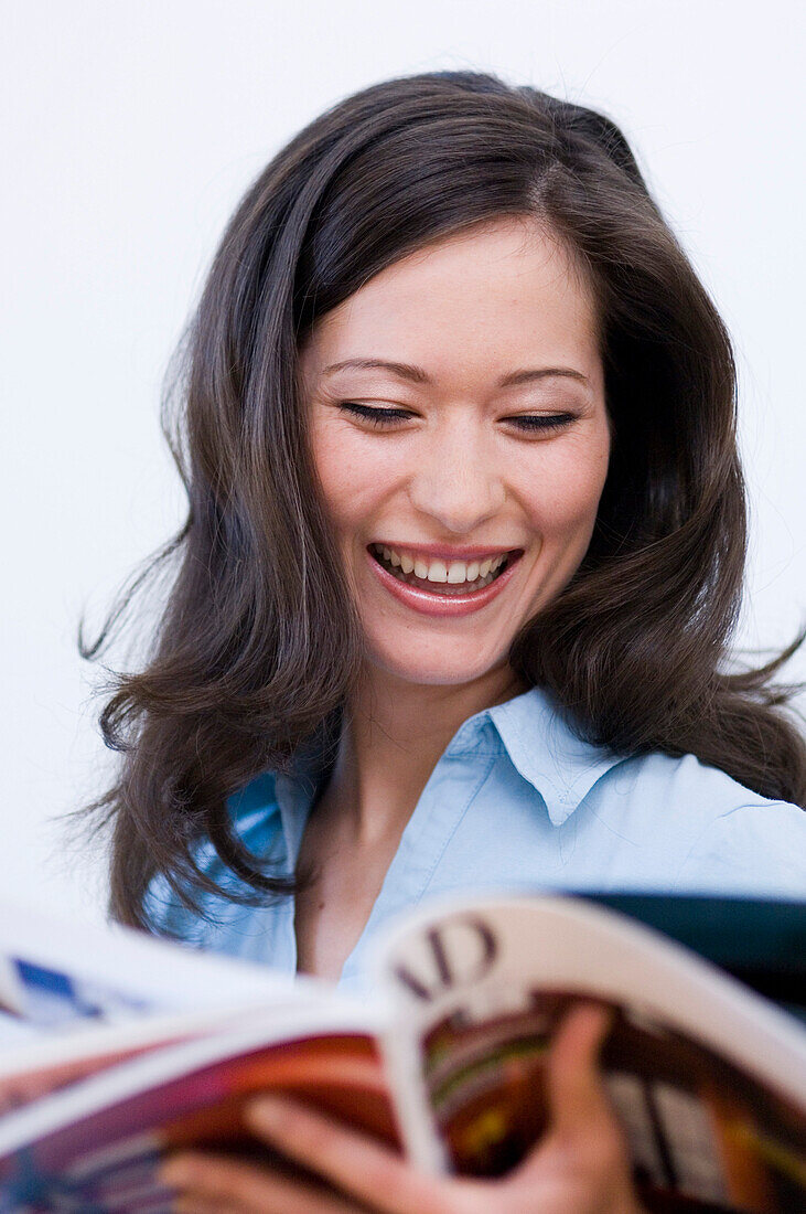 Young woman reading a journal