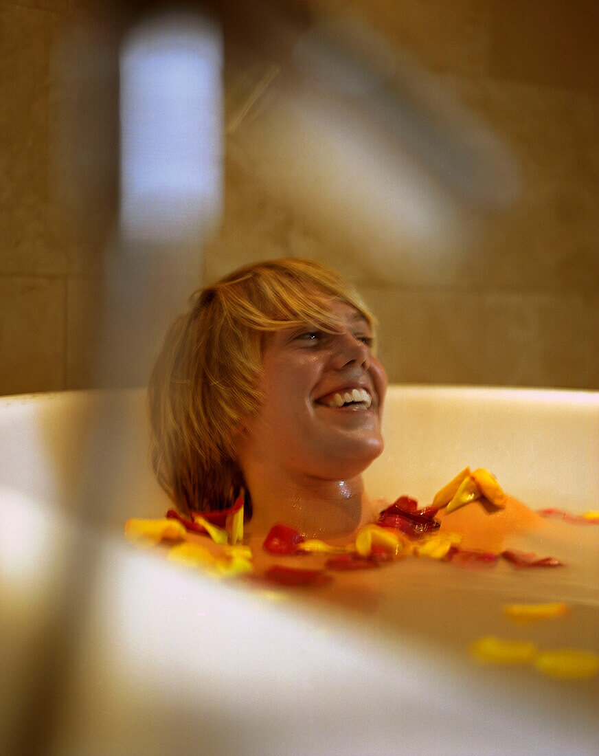 Young Woman in bathtub with rose petals
