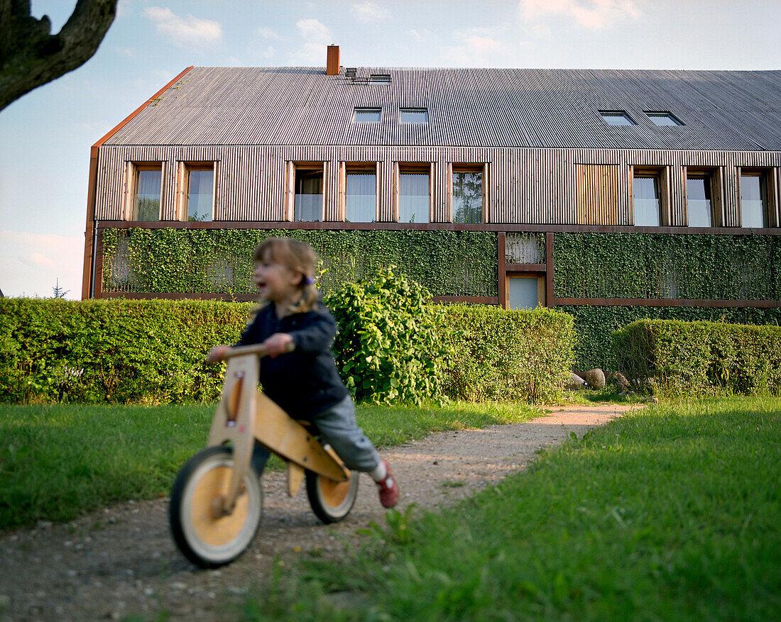Girl (3 years) on a running wheel, Seehotel Neuklostersee, Lake Neukloster, Nakenstrof, Mecklenburg-Western Pomerania, Germany