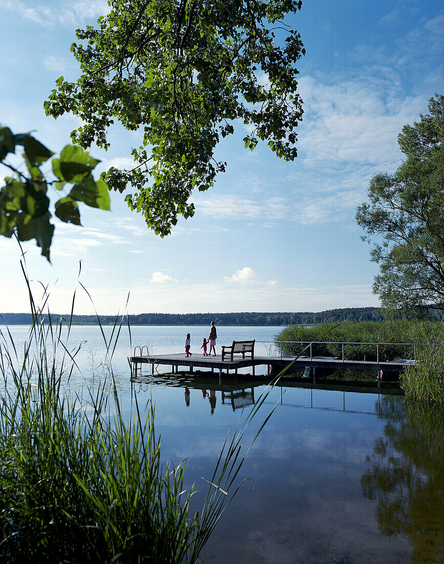 Mother with two children on a jetty Seehotel Neuklostersee, Lake Neukloster, Nakenstrof, Mecklenburg-Western Pomerania, Germany