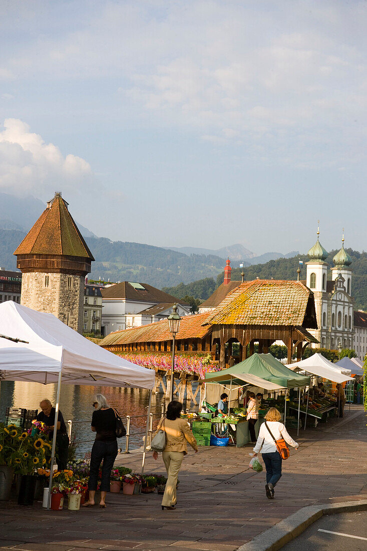 Farmer's market at entry of the Kapellbrücke (chapel bridge, oldest covered bridge of Europe) and Wasserturm, Lucerne, Canton Lucerne, Switzerland