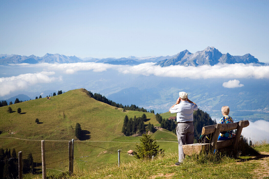 Senior couple enjoying view over Rigi Kulm (1797 m) to Pilatus (2132 m), Rigi Kulm, Canton of Schwyz, Switzerland