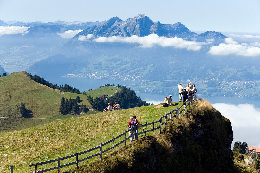 Hikers on Rigi Kulm (1797 m) enjoying the view over Lake Lucerne to Pilatus (2132 m), Rigi Kulm, Canton of Schwyz, Switzerland