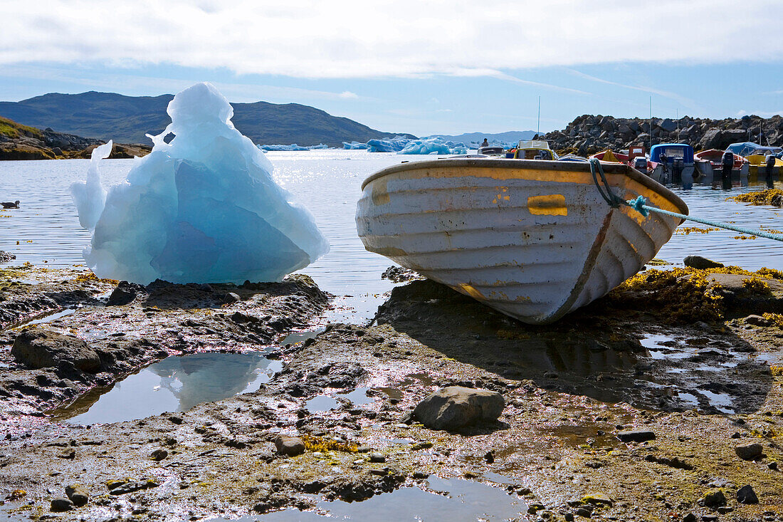 Stranded icebergs and a small boat at Narsaq, South Greenland