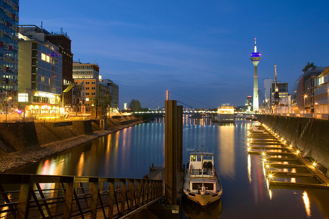 Modern architecture in the Media Harbour with television tower in the evening, Düsseldorf, state capital of NRW, North-Rhine-Westphalia, Germany