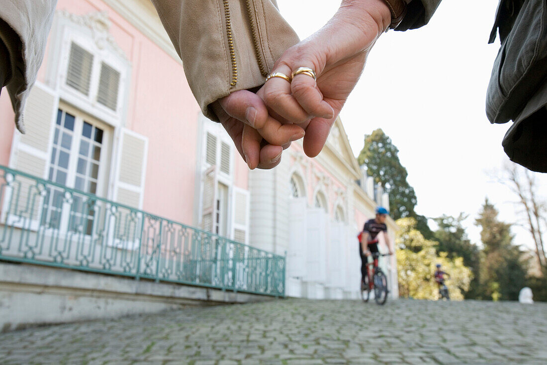 Couple holding hands at Benrath castle, Düsseldorf, state capital of NRW, North-Rhine-Westphalia, Germany