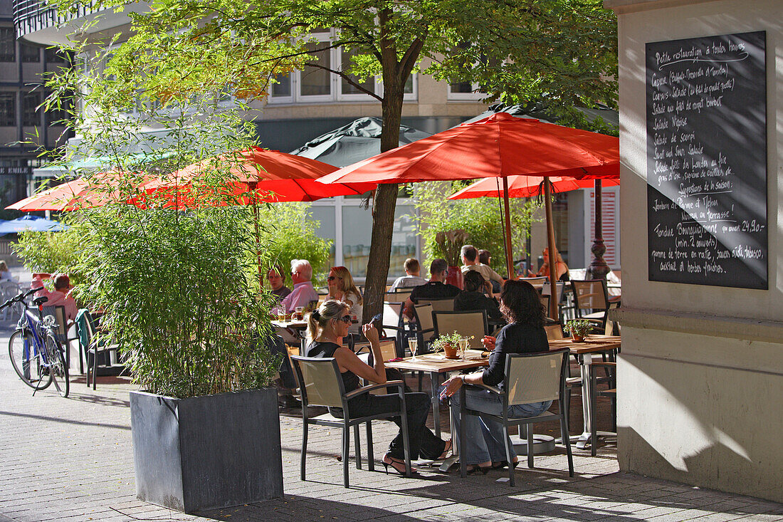 People sitting under sunshades of a Bistro in pedestrian area, Rue de la Poste, Luxembourg, Luxembourg, Europe