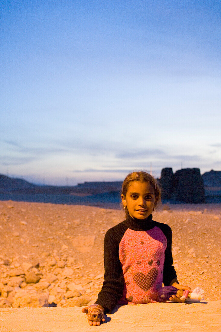 An Egyptian girl at sunset at a temple in Luxor, Egypt