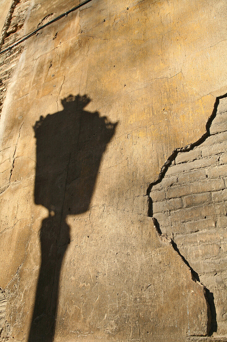 shadow of street lamp on old wall, Valencia, Spain