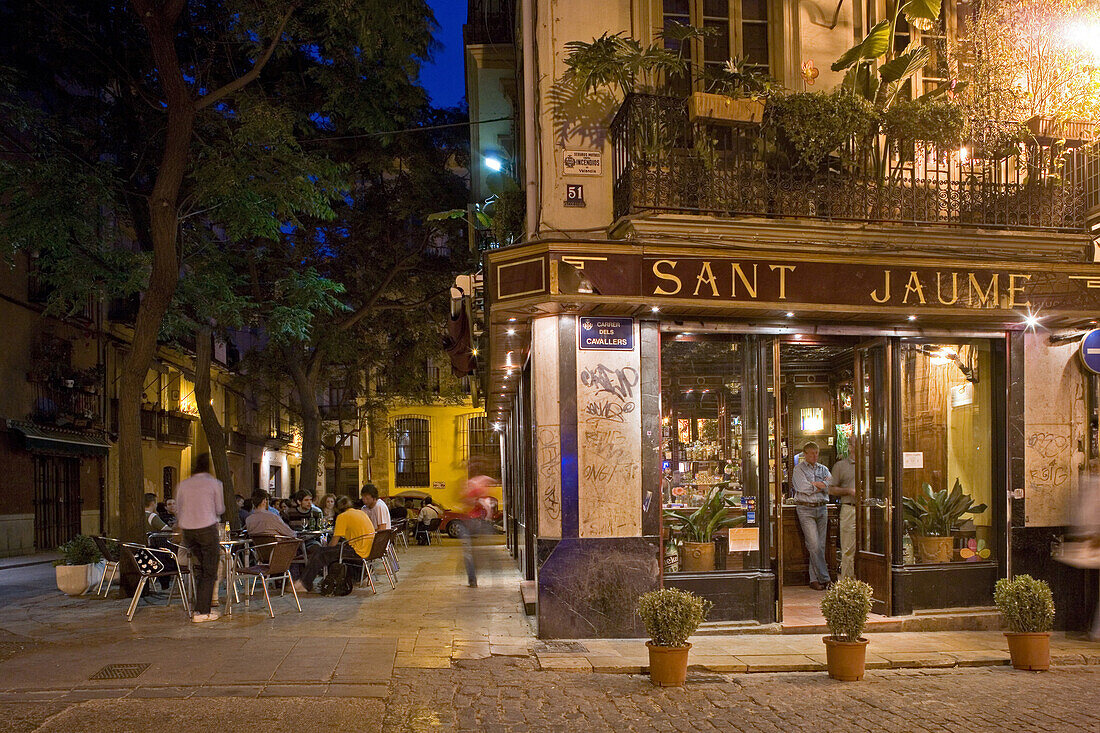Sant Jaume, outdoor Cafe with young people sitting on a Square, old town, Barrio del Carmen evening, Valencia, Spain