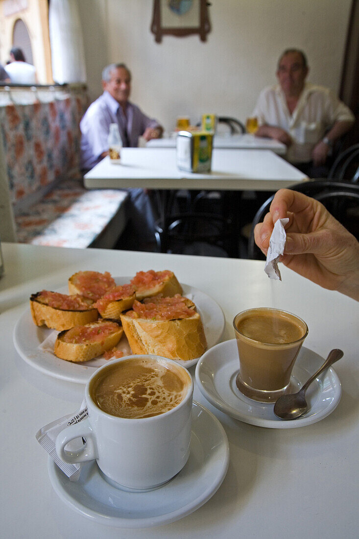 Espresso coffee with milk in a glass, a cortado, cup of coffee, white bread with tomatoes, tapas, Spanish restaurant, Valencia, Spain