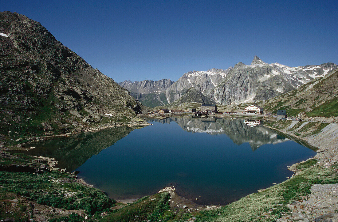 Mirroring of mountains on water surface of a lake, Great St Bernard Pass, Canton of Valais, Switzerland
