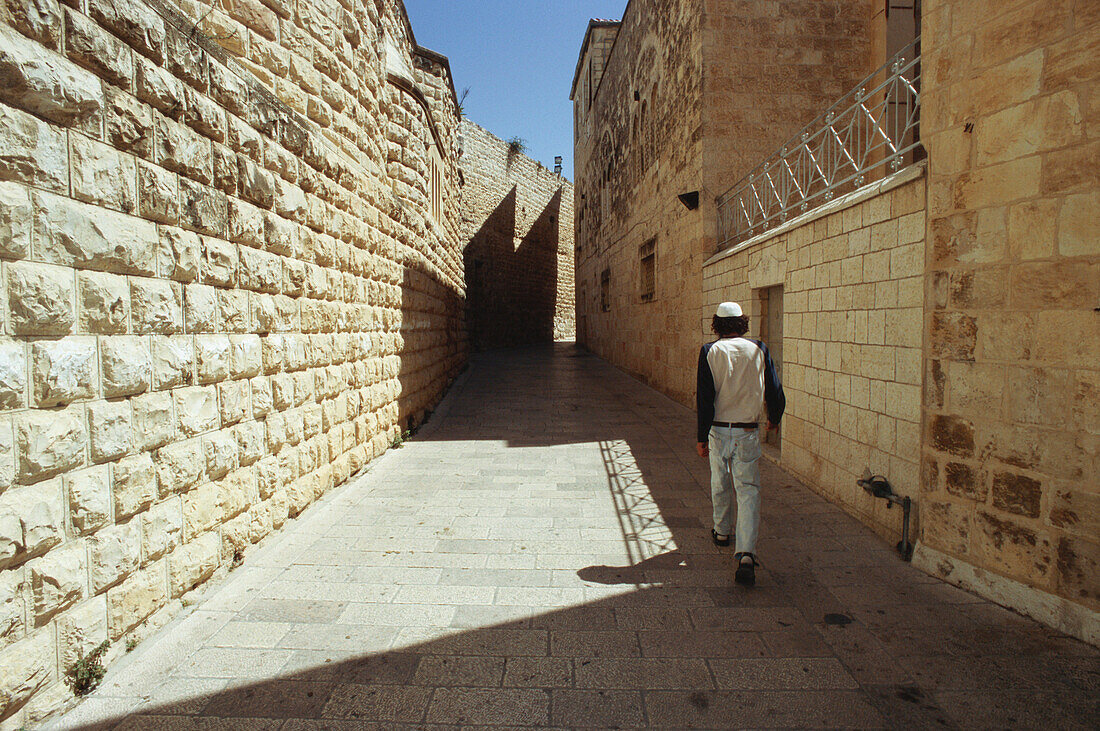 Young adult walking along the Jewish quarter, Jerusalem, Israel