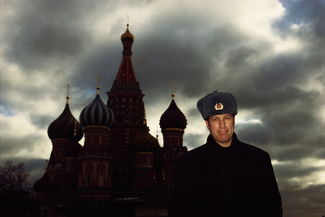 Man standing in front of Saint Basil's Cathedral wearing hat, Moscow, Russia