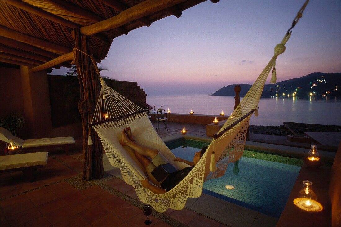 Man relaxing in a hammock, Suite, Small Luxury Hotel, La Casa que canta Zihuatanejo, Guerrero, Mexico, America