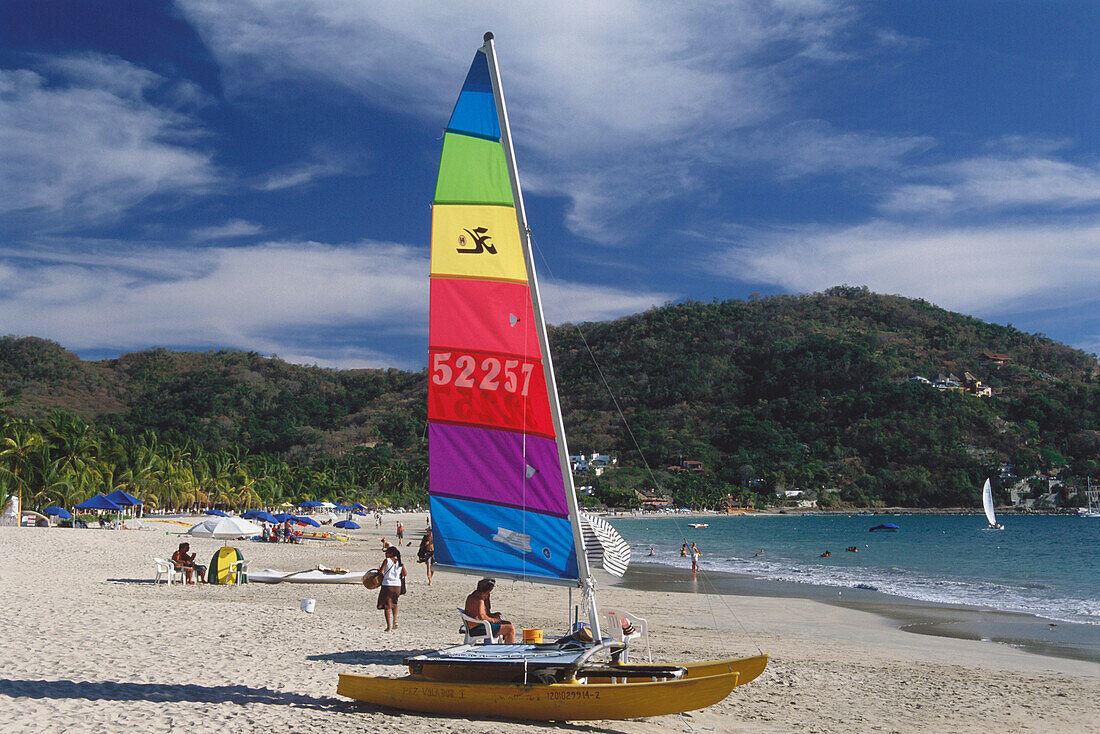 A boat, catamaran, on the beach at Playa la ropa, Zihuatanejo, Guerrero, Mexico, America