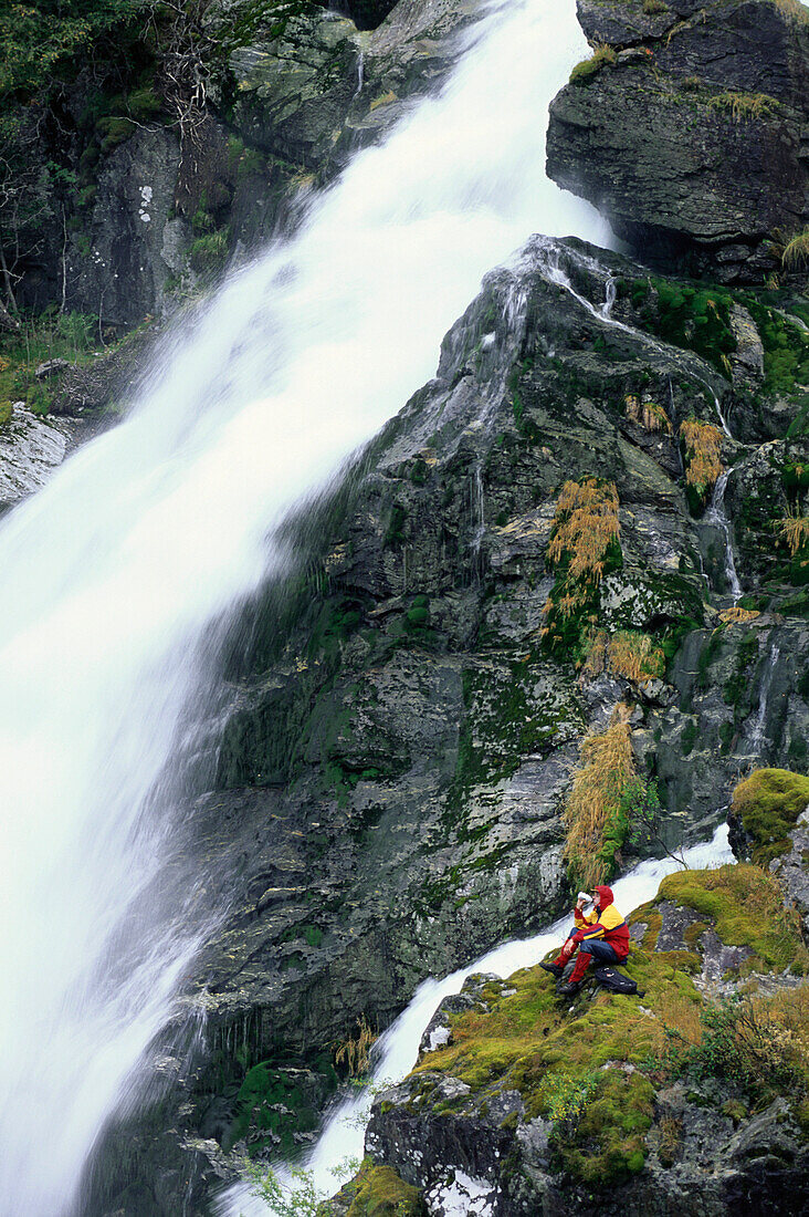 Hikers having a rest, Kleivafossen at the Briksdal Glacier, Norway