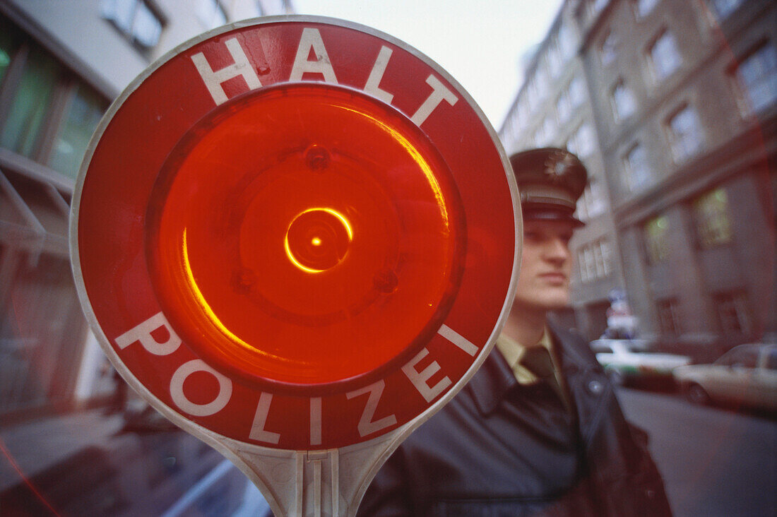 Traffic policeman holding a stop sign, Stop police, Munich, Bavaria, Germany