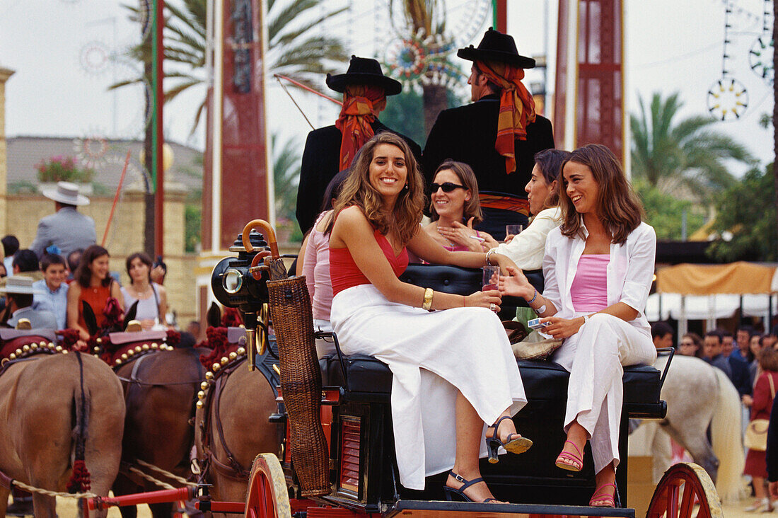 Women in a horse carriage at Feria del Caballo, Jerez de la Frontera, Provinz Cadiz, Andalusia, Spain