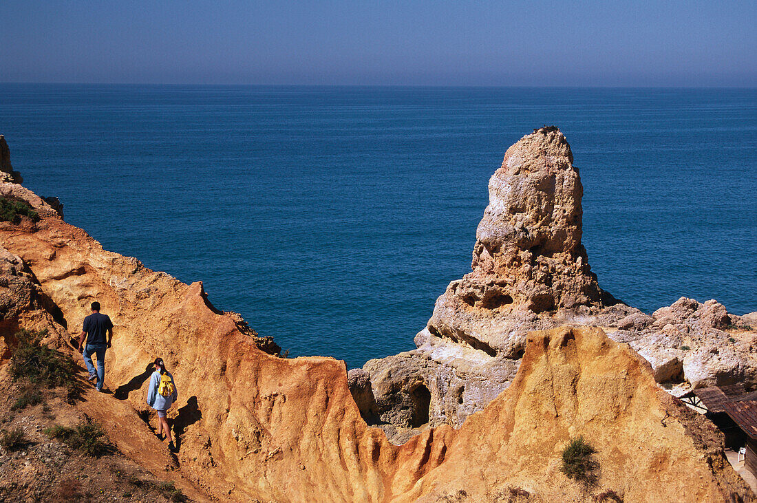 Two people hiking, Algar Seco near Carvoeiro, Algarve, Portugal