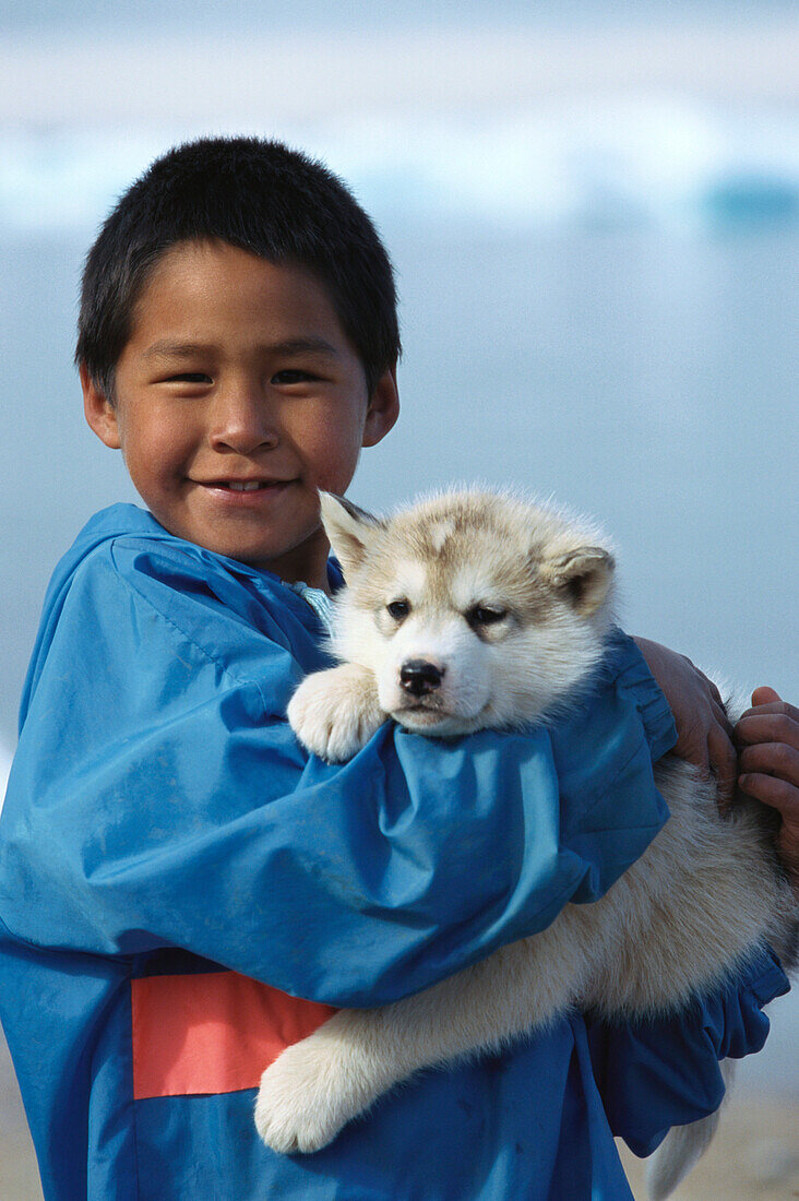 Inuit boy with sled dog, husky, Northwest Territories, Canada