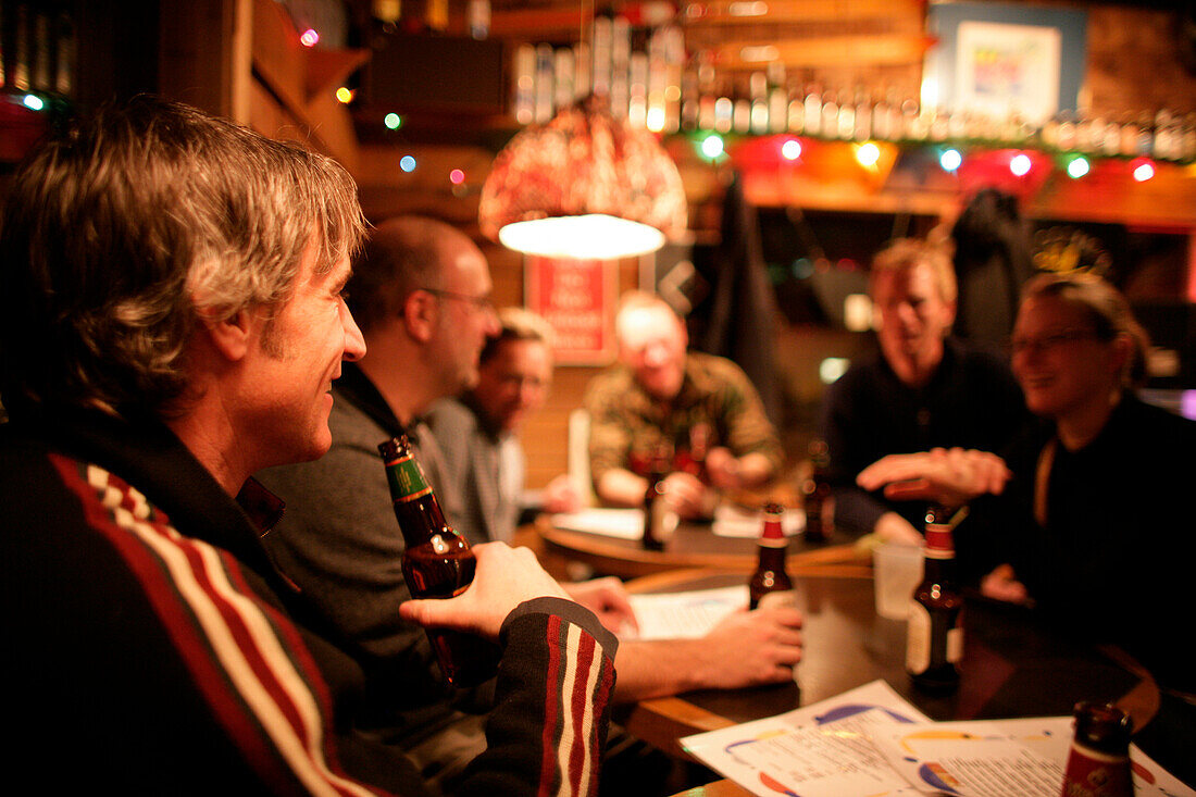 People drinking beer in the T-Bar pub, Castle Mountain ski resort, Alberta, Canada