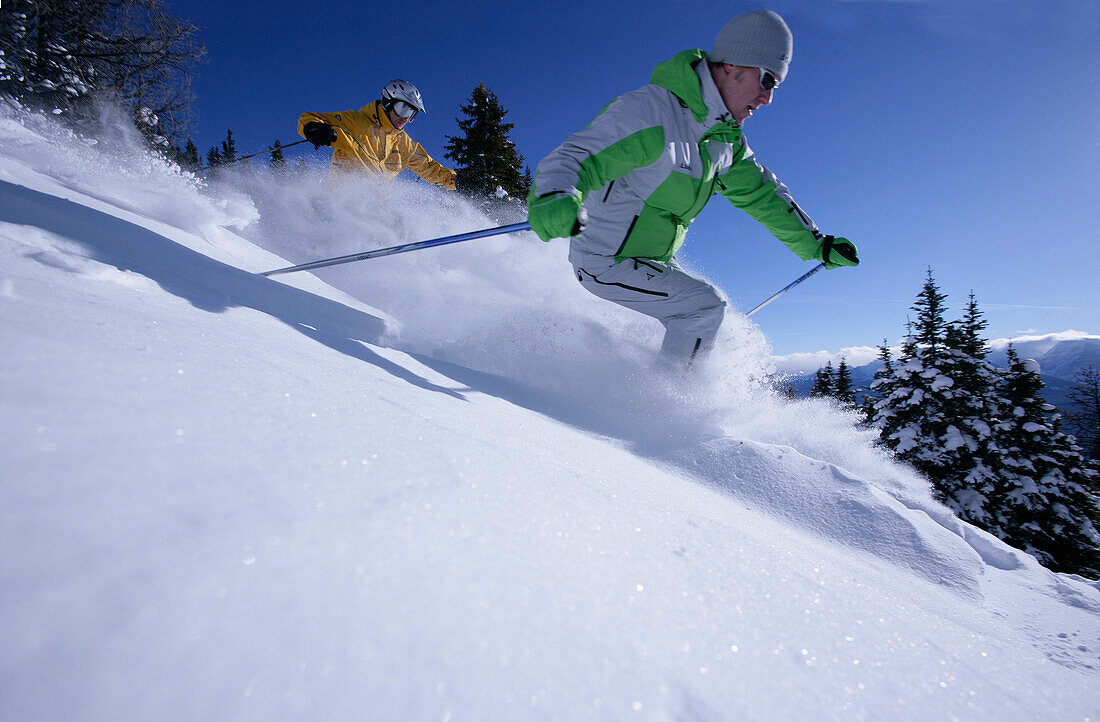 Two skiers in deep snow, Lake Louise, Alberta, Canada