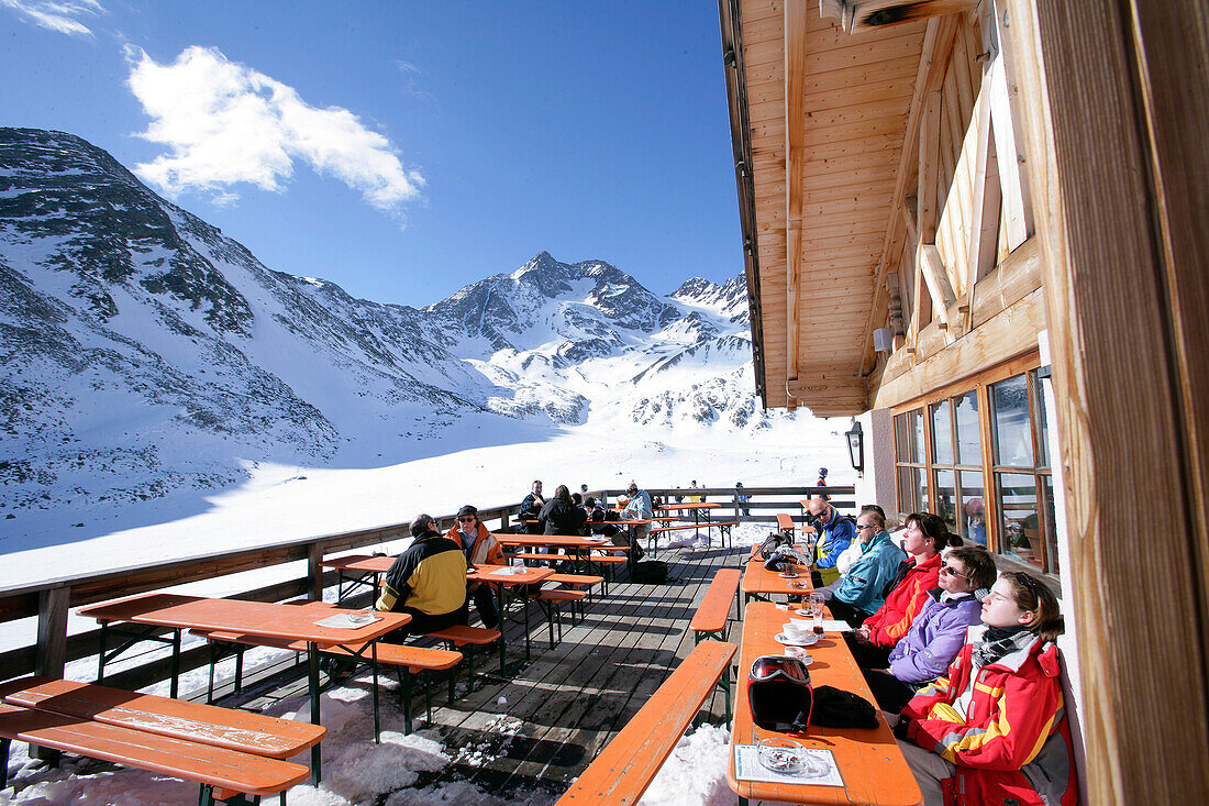 Skiers on the terrace of a mountain restaurant, alpine hut, Lazaun Upper Station, Schnalstal, South Tyrol, Italy