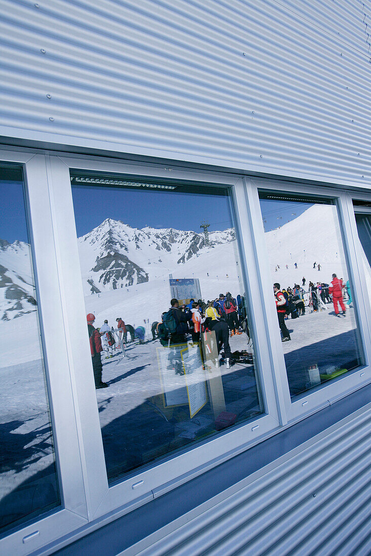 Reflection of people in window, upper station building, Galzig peak, St Anton, Tyrol, Austria