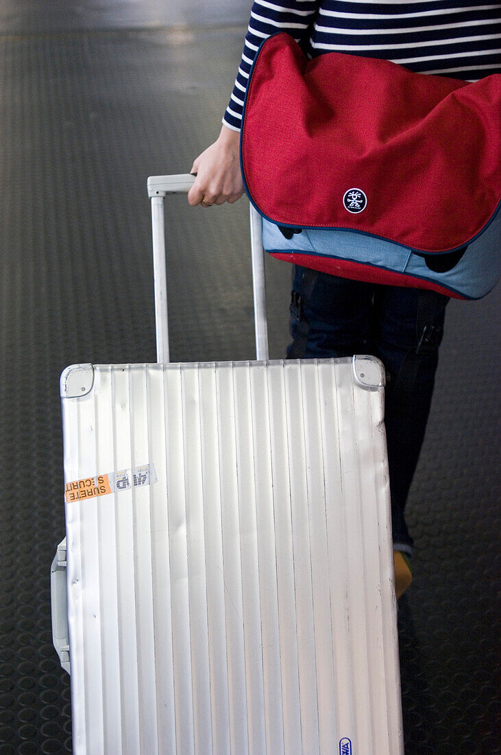 Woman with aluminium suitcase, airport, Luxemburg