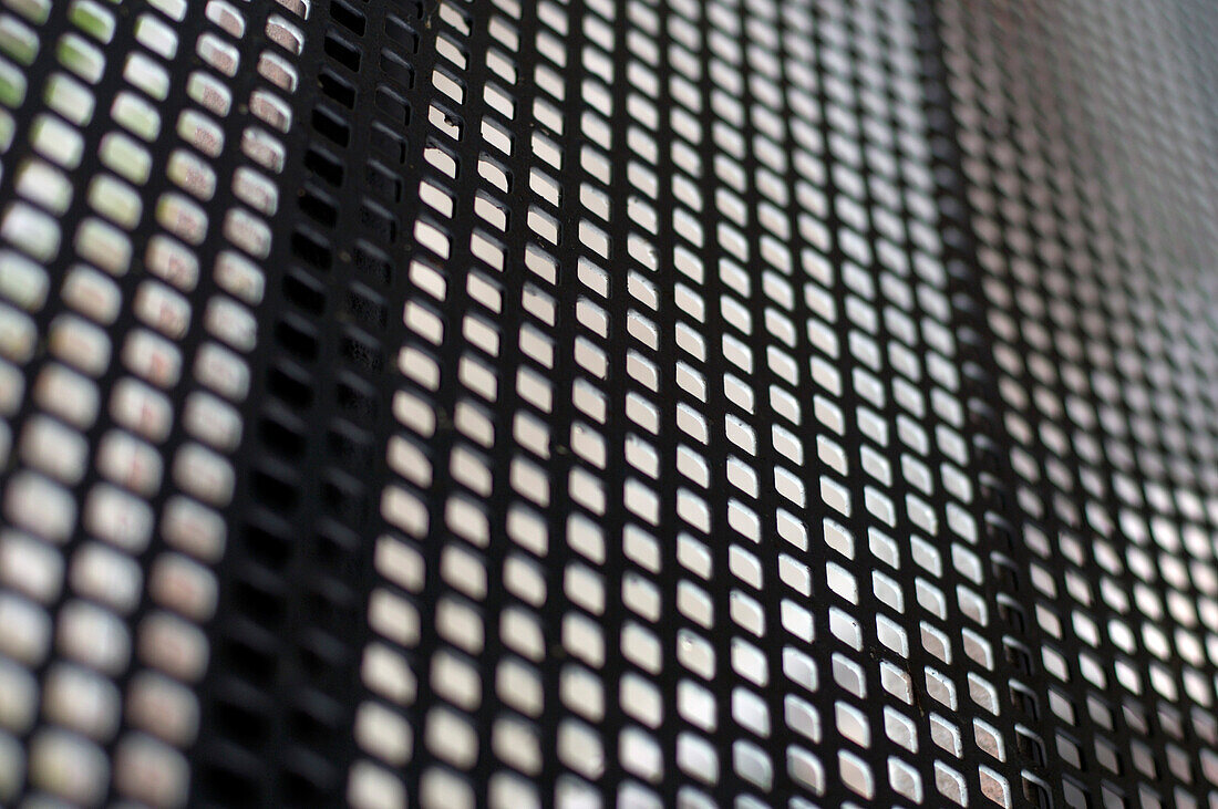 Hole pattern in a metal bar, detail