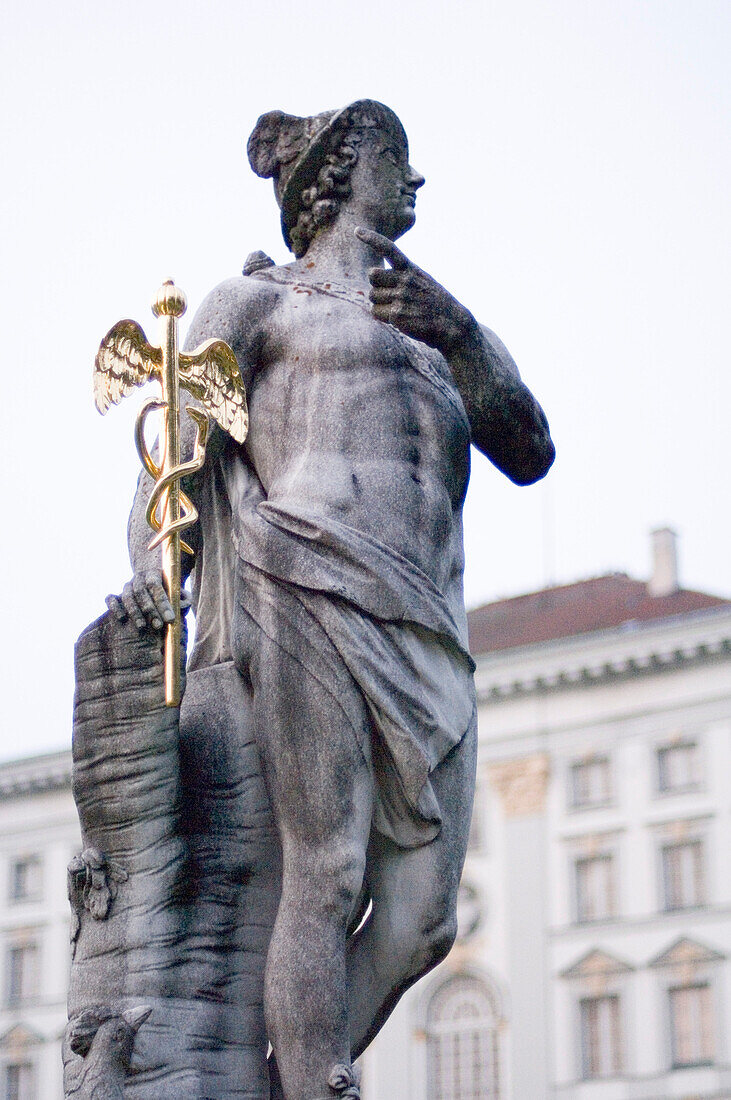 Sculpture made of stone in front of the facade of Nymphenburg castle, Munich, Bavaria, Germany