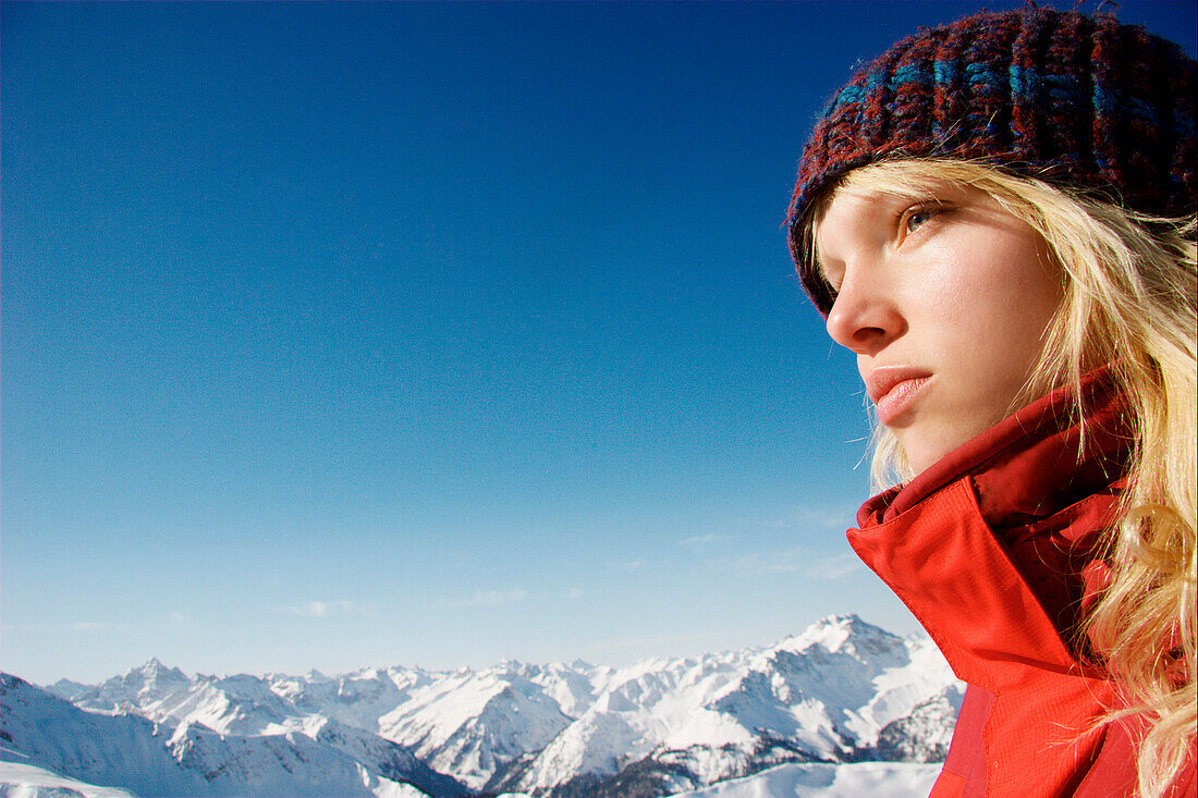 Reflective young woman looking at view, mount Rohnenspitze, Tannheim Valley, Tyrol, Austria